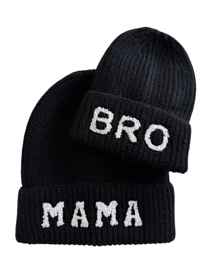Two black knitted beanies with the words "MAMA" and "BRO" in white letters.