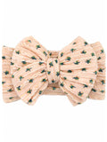 Pink floral hair bow with textured fabric and green accents. Ideal accessory for adding style.