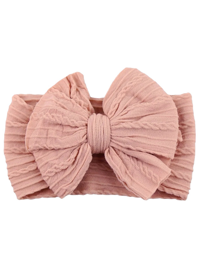 Light pink headband with a textured bow design, ideal for children's accessories.