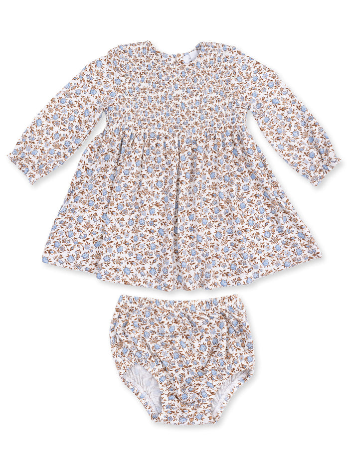 Floral smocked baby dress with long sleeves and matching bloomers in soft white, blue, and brown colors.