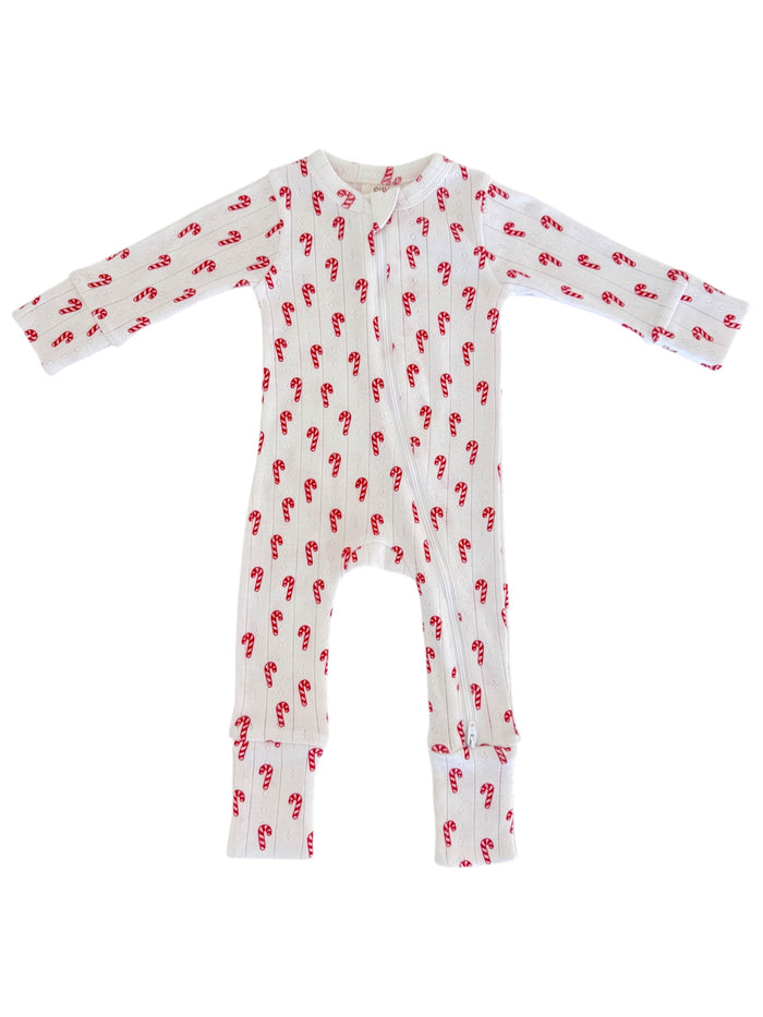 White toddler onesie with red candy cane pattern and long sleeves. Front zipper for easy dressing.