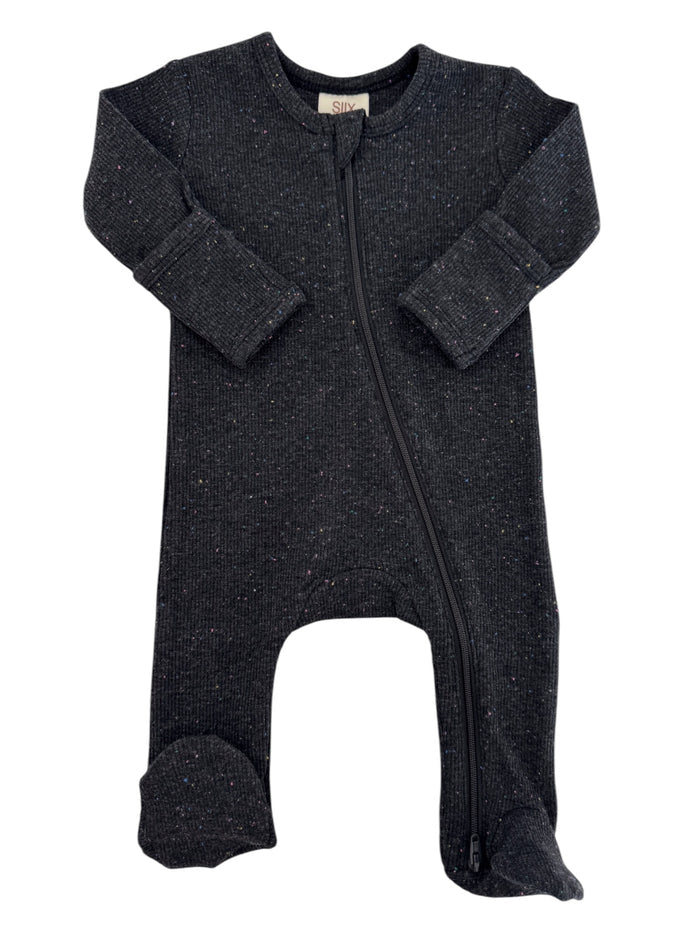 Black infant bodysuit with colorful specks and a front zipper, featuring long sleeves and footed design.