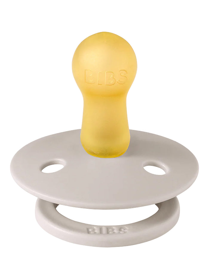 Yellow rubber pacifier with a gray silicone shield, featuring the brand name "BIBS" embossed on the handle.