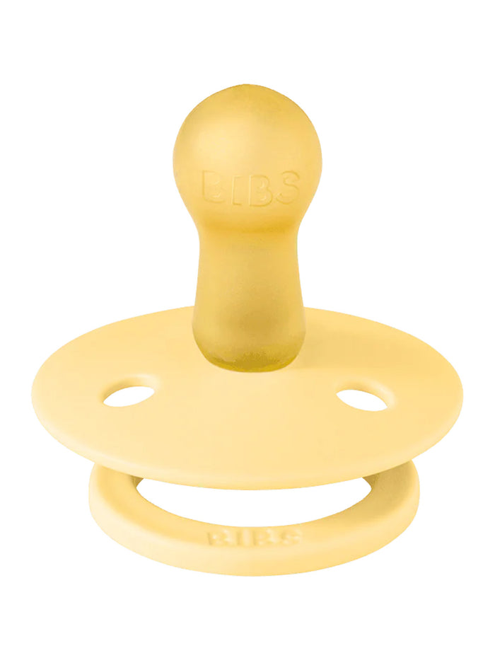 Yellow rubber pacifier with the brand name "BIBS" embossed on the handle and a round nipple.