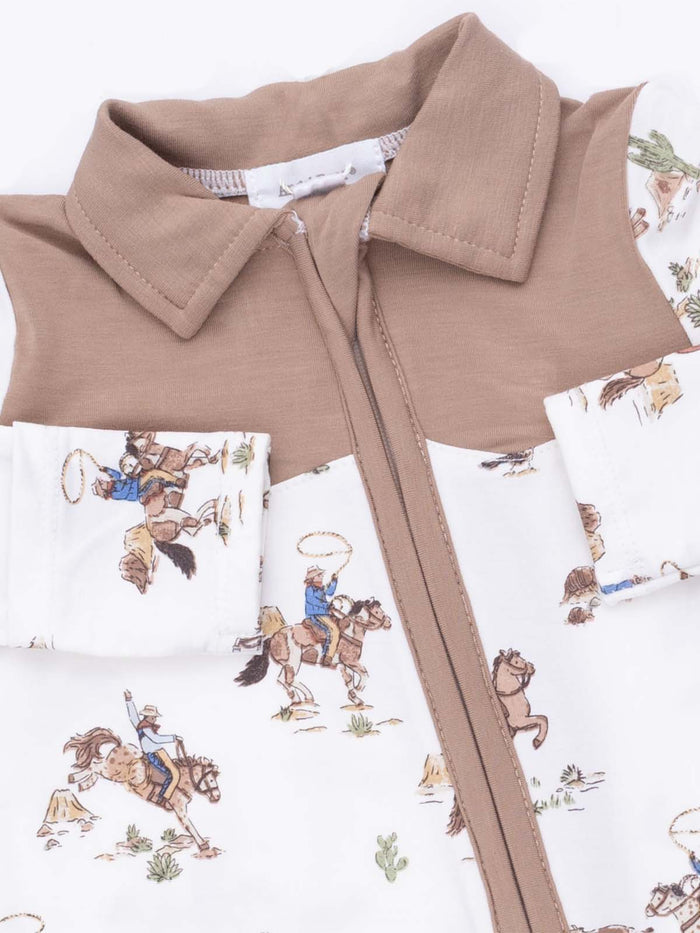 Children's shirt with cowboy print, featuring brown collar and sleeves, showcasing rodeo scenes and cacti.