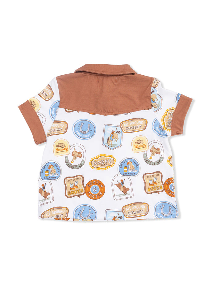 Back view of a children's polo shirt featuring cowboy-themed patches and a brown collar. Ideal for casual wear.