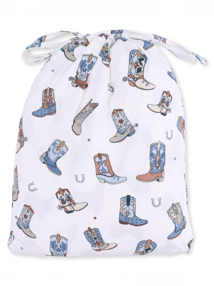 Drawstring bag with a whimsical pattern of cowboy boots and cacti on a white background.