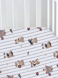 Crib sheet featuring playful teddy bears in sports attire on a blue striped background.