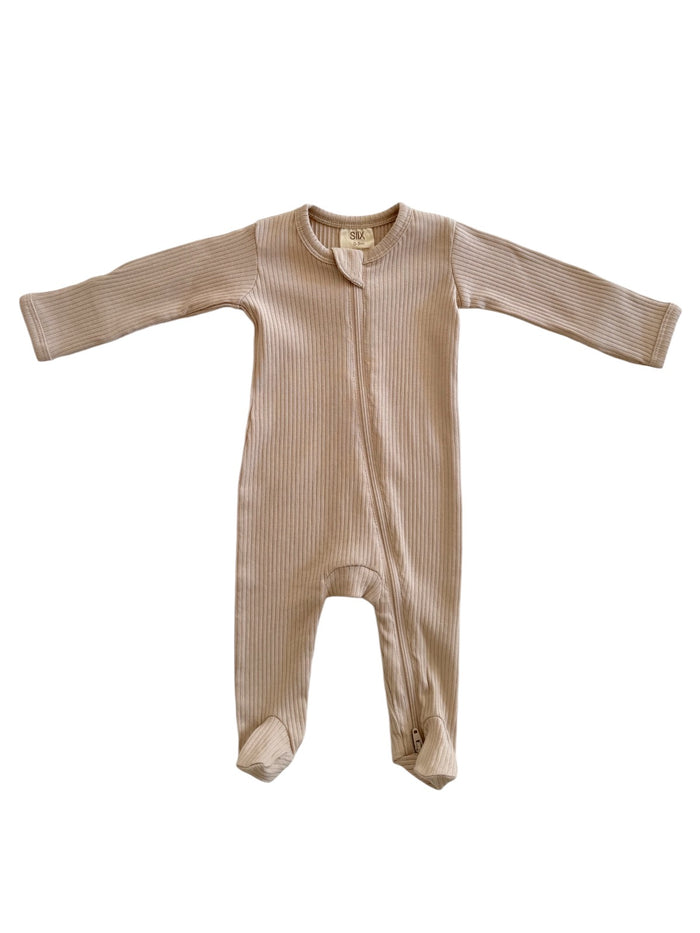 Beige ribbed baby onesie with long sleeves and a front zipper, designed for comfort and ease.