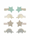 Set of hair clips featuring mint green stars and sparkly dinosaur designs in gold and silver.