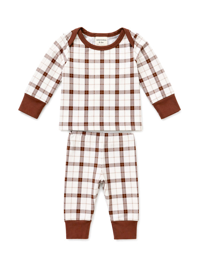 Brown and white plaid baby pajama set with long sleeves and pants. Soft fabric and comfortable design for infants.