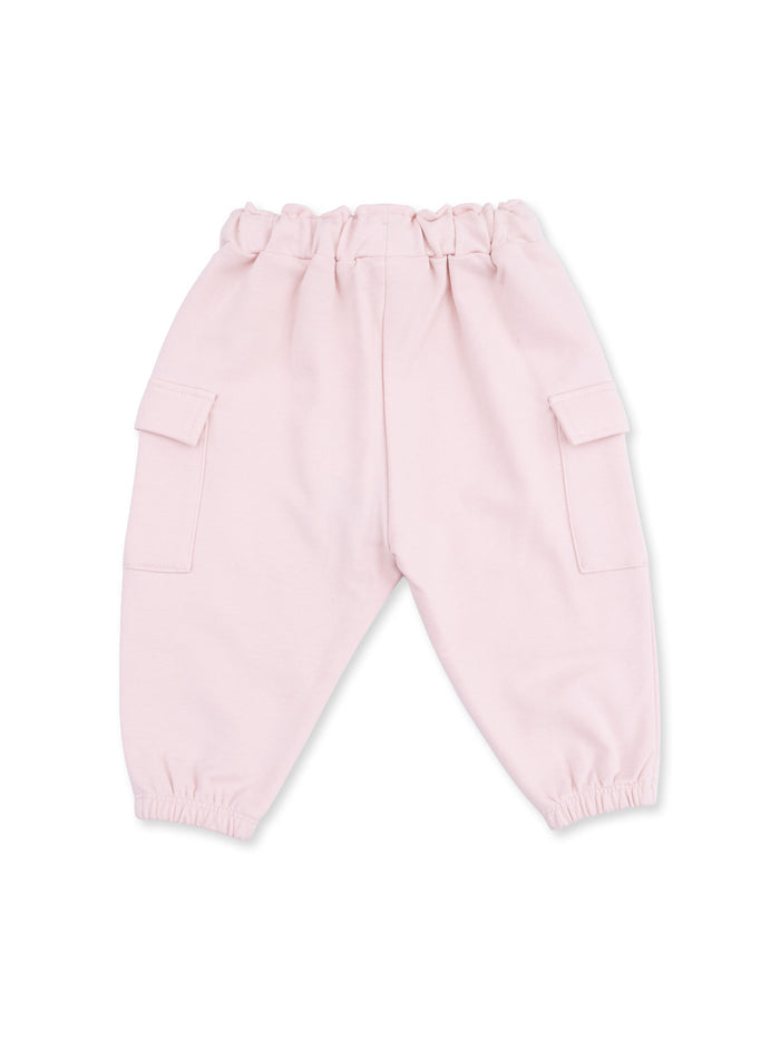 Light pink cargo pants with an elastic waistband and pockets on each side.