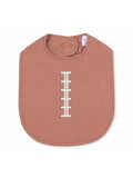 Pink baby bib with a football stitch design, featuring a snap closure at the neck. Ideal for mealtime.