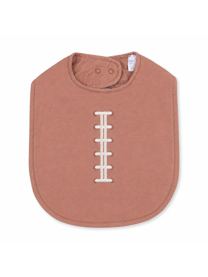 Pink baby bib with a football stitch design, featuring a snap closure at the neck. Ideal for mealtime.