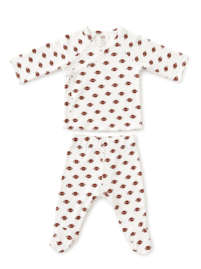 Baby outfit featuring a long-sleeve top and pants with a football pattern on a white background.