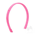 A pink headband with a Grosgrain-wrapped design, looped for adding a bow.