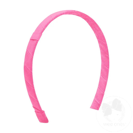 A pink headband with a Grosgrain-wrapped design, looped for adding a bow.
