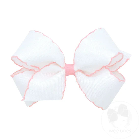 White bow with pink trim on a white background