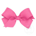 A pink grosgrain hair bow attached to a clip, displayed on a white background.