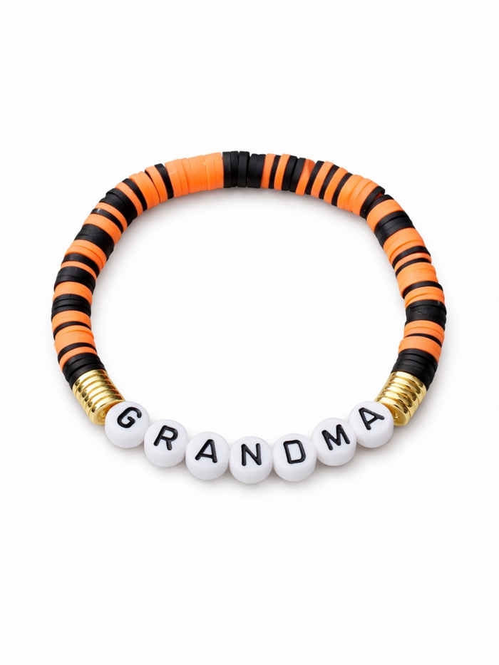 Colorful beaded bracelet with the word "GRANDMA" in white beads surrounded by orange and black discs.