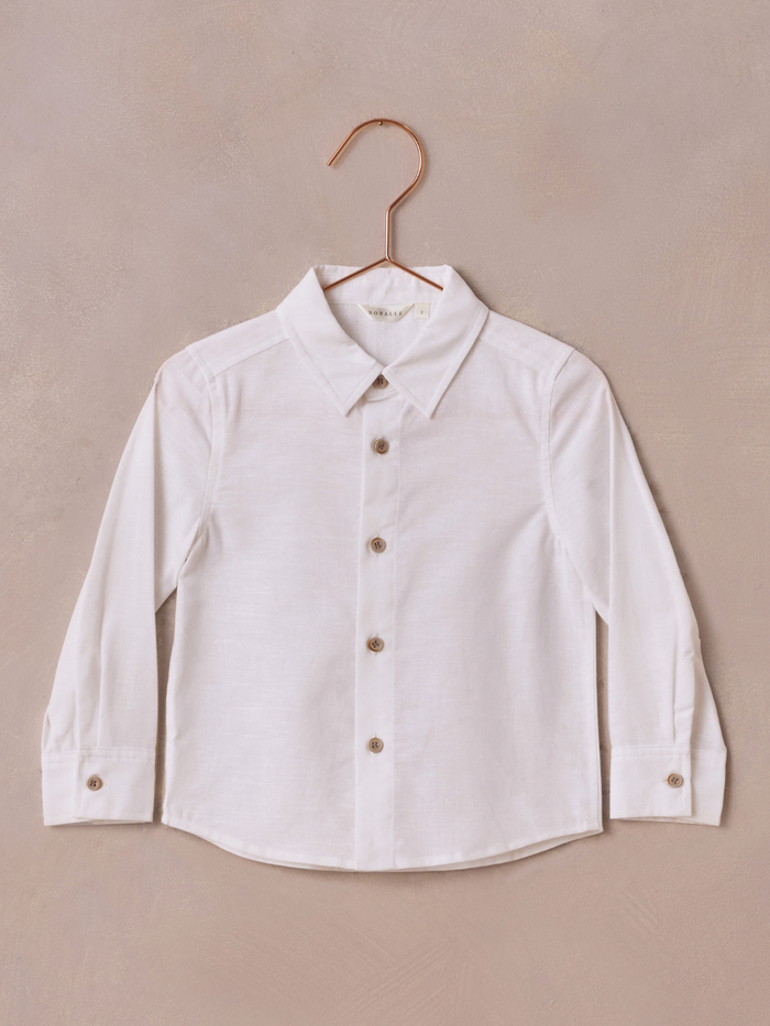 White long-sleeve button-up shirt on a copper hanger against a neutral background.