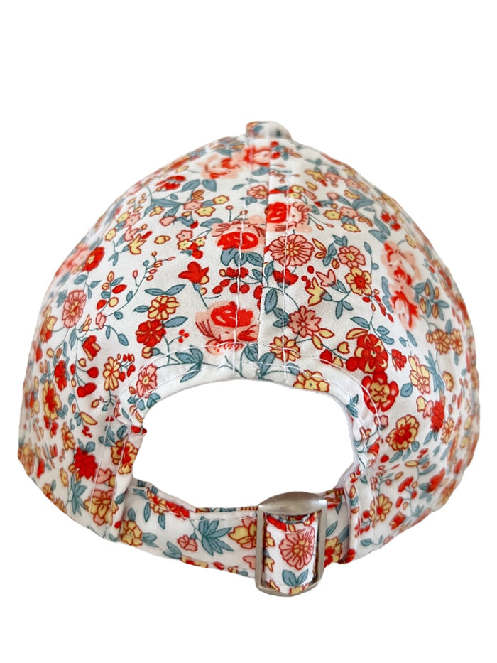 Back view of a floral baseball cap featuring red and blue flowers on a white background.