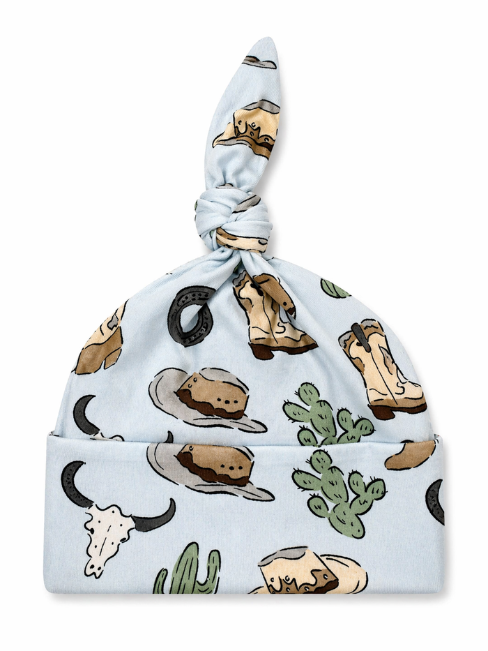 Blue baby hat adorned with cowboy-themed patterns, including hats, boots, cacti, and horseshoes.