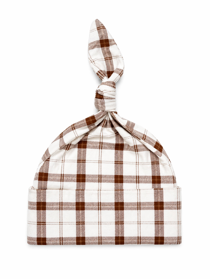 White and brown plaid baby hat with a knot at the top, suitable for infants.
