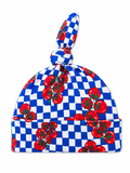 Blue and white checkered hat with red tomato patterns and a knot on top.