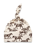 Cotton baby hat with a knot, featuring a brown horse print on a cream background.
