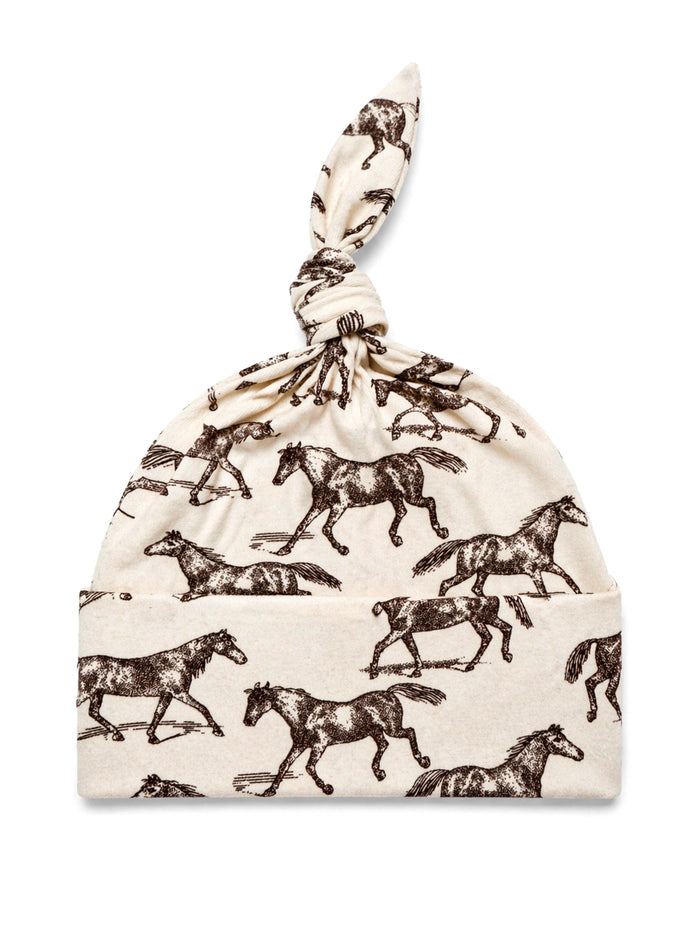 Cotton baby hat with a knot, featuring a brown horse print on a cream background.