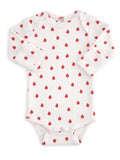 White baby bodysuit with red strawberry pattern and long sleeves, featuring snap closures at the bottom.