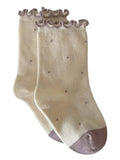 Cream-colored socks with ruffled openings and polka dots, featuring a beige toe.