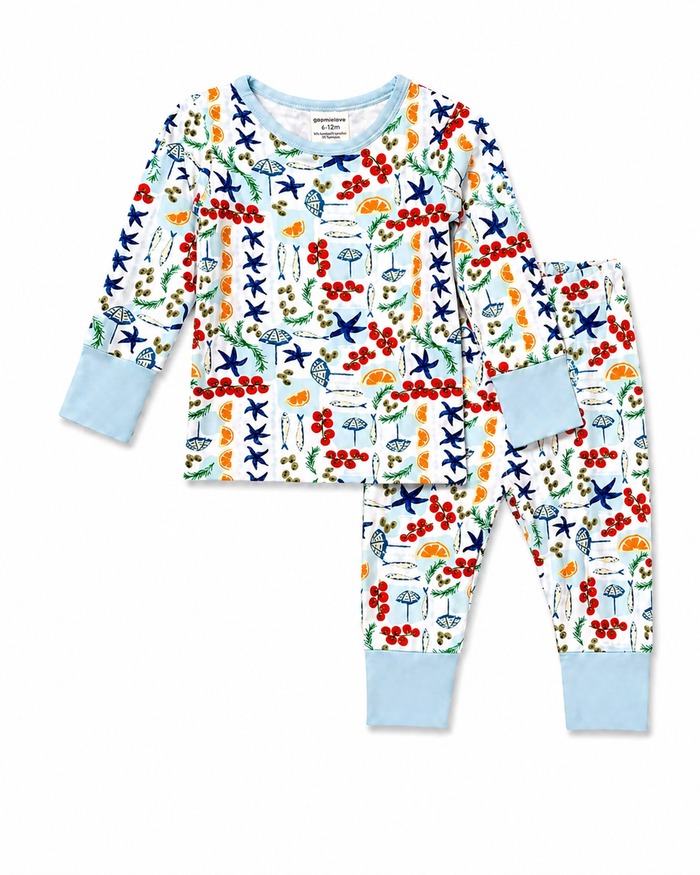 Colorful children's pajamas featuring playful floral and aquatic designs in blue, red, and orange tones.