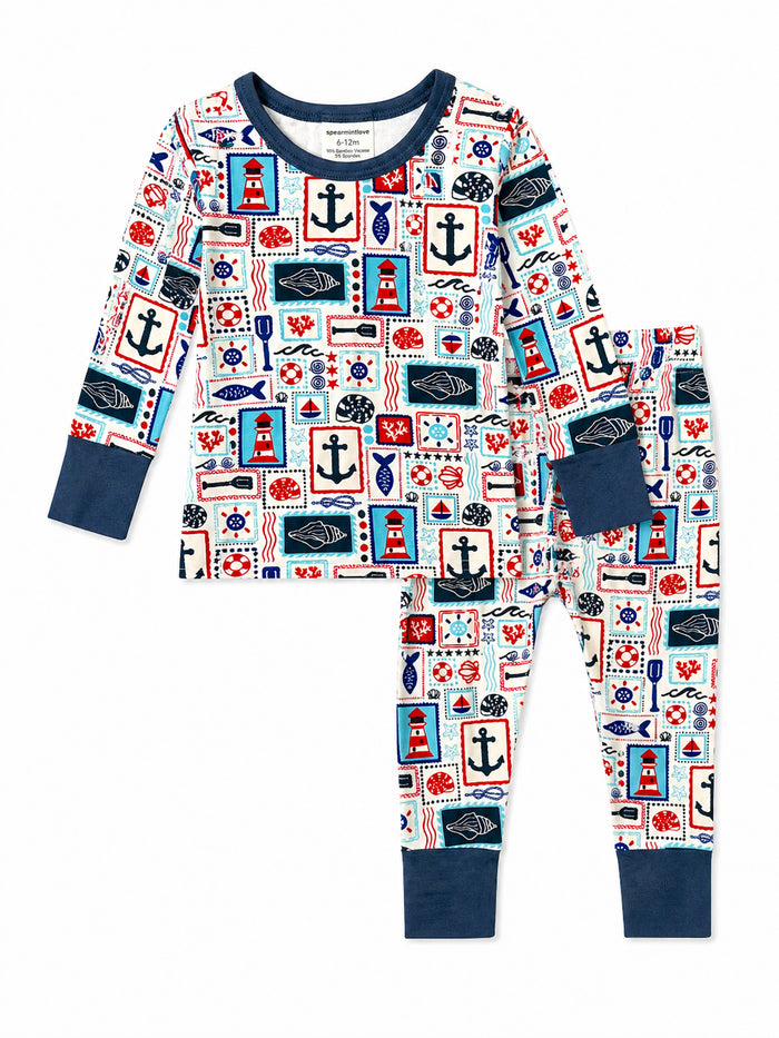 Colorful toddler pajamas featuring a nautical print of anchors, lighthouses, and marine elements.