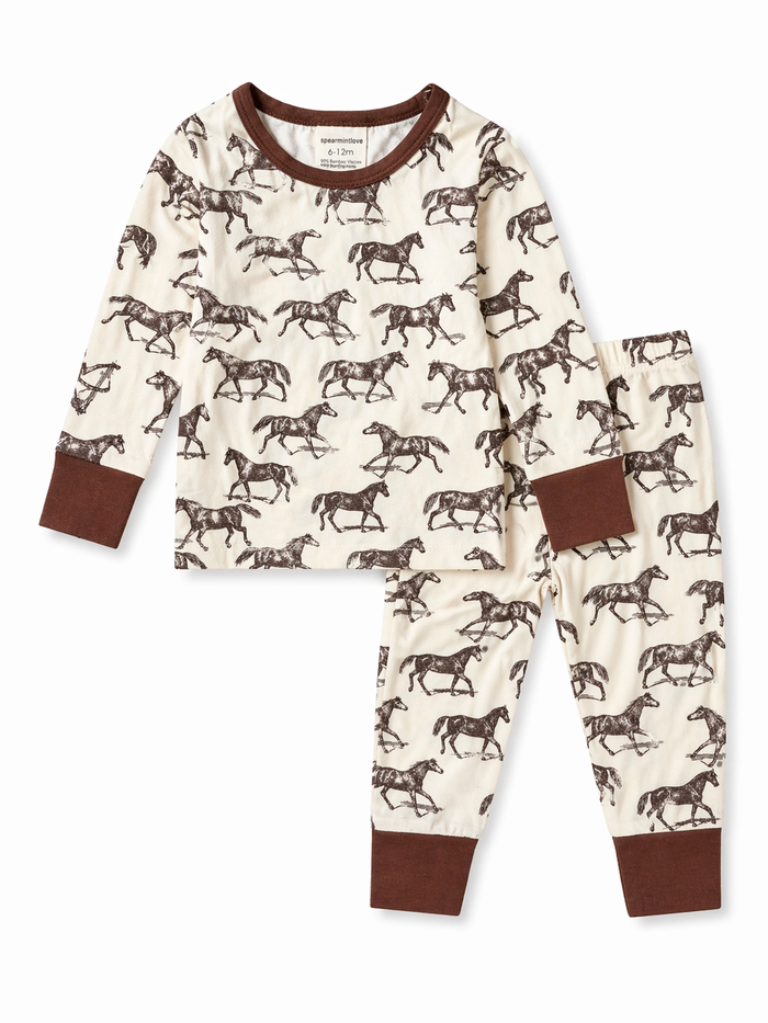 Children's pajamas featuring an all-over horse print in cream and brown colors. Ideal for cozy bedtime.