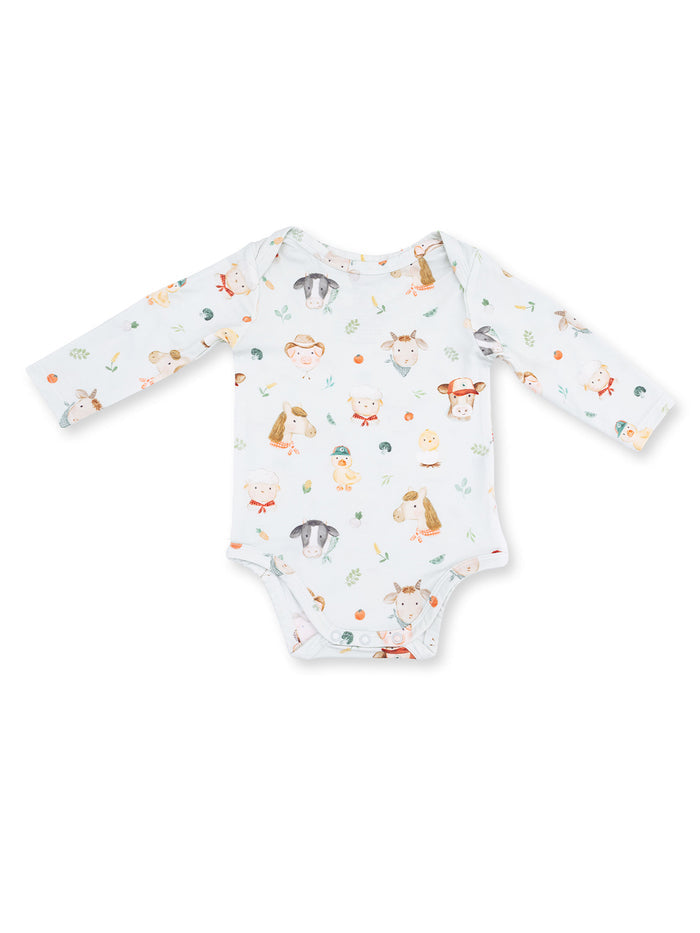 Long-sleeve baby bodysuit with a playful animal print design in soft colors on a light background.