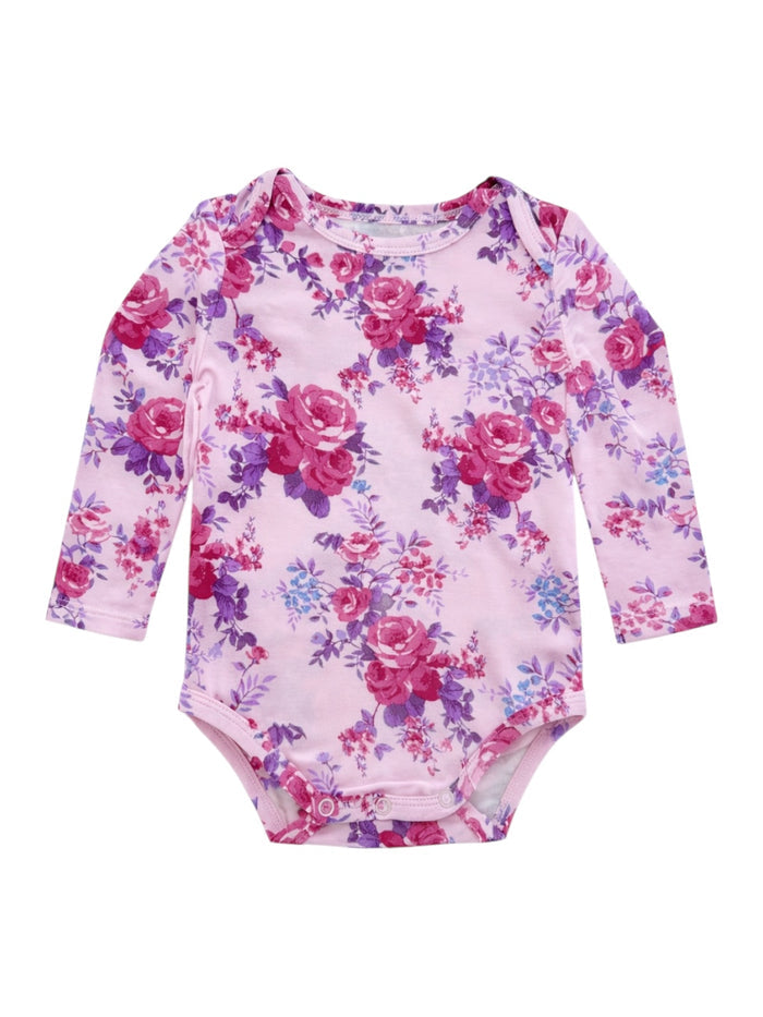 Pink floral long-sleeve baby bodysuit with purple and red roses on a soft fabric background.