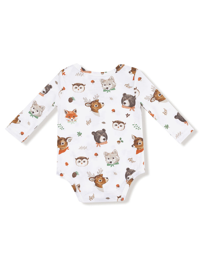 White baby onesie with cute animal prints including a deer, bear, fox, owl, and other woodland creatures.