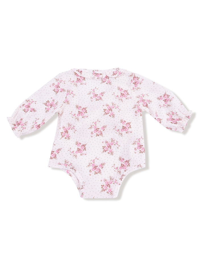 Long-sleeve baby bodysuit with floral pattern on white background and polka dots, featuring a rounded collar.