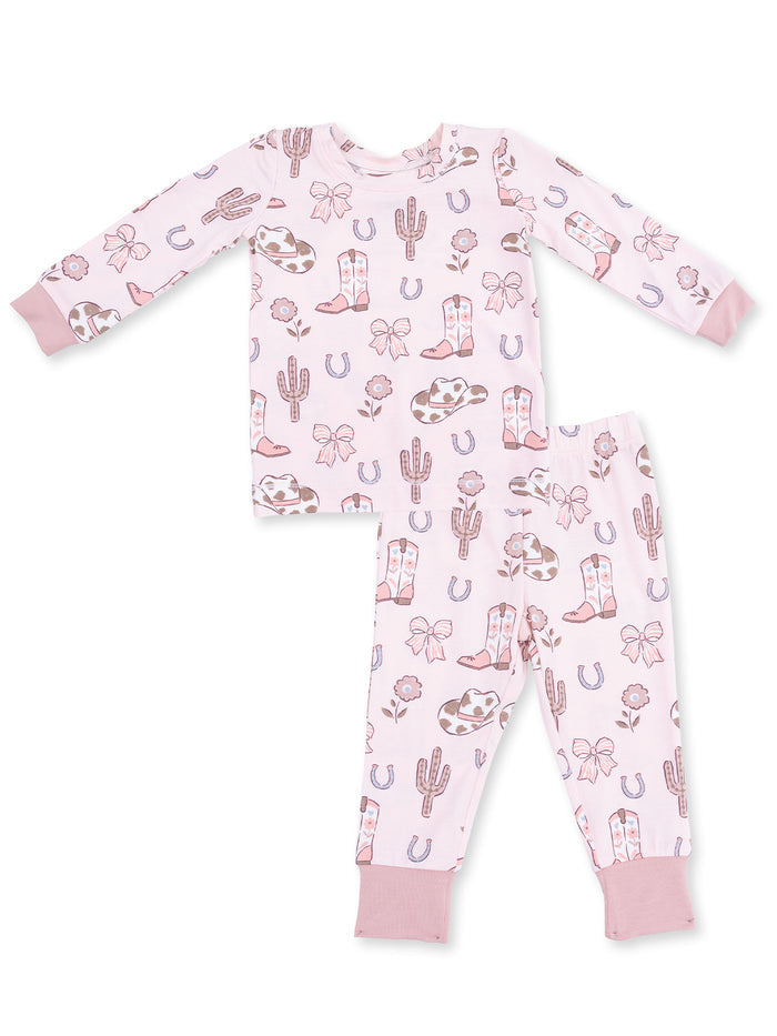 Pink children's pajamas featuring cowboys, cacti, and floral patterns, with long sleeves and matching pants.