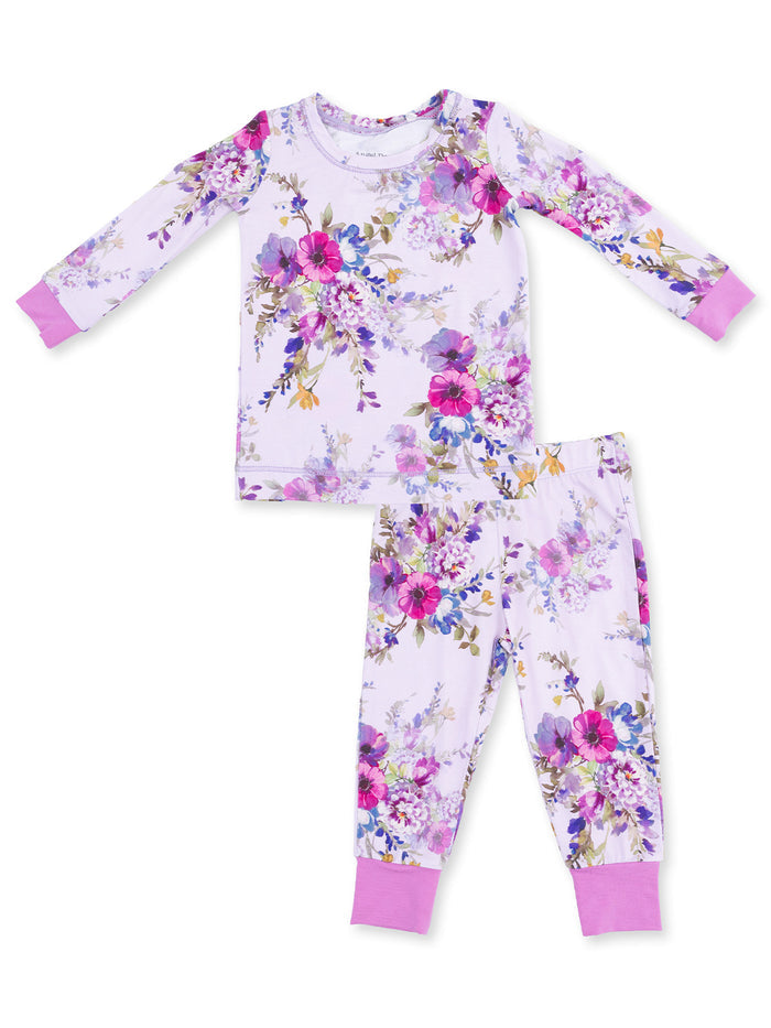 Floral long-sleeve pajama set with purple accents for kids. Features vibrant flowers on a light background.