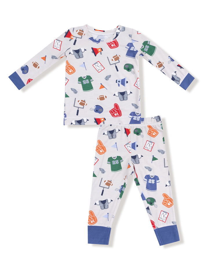Children's pajamas featuring colorful sports-themed graphics on a light background. Long-sleeve top and pants set.