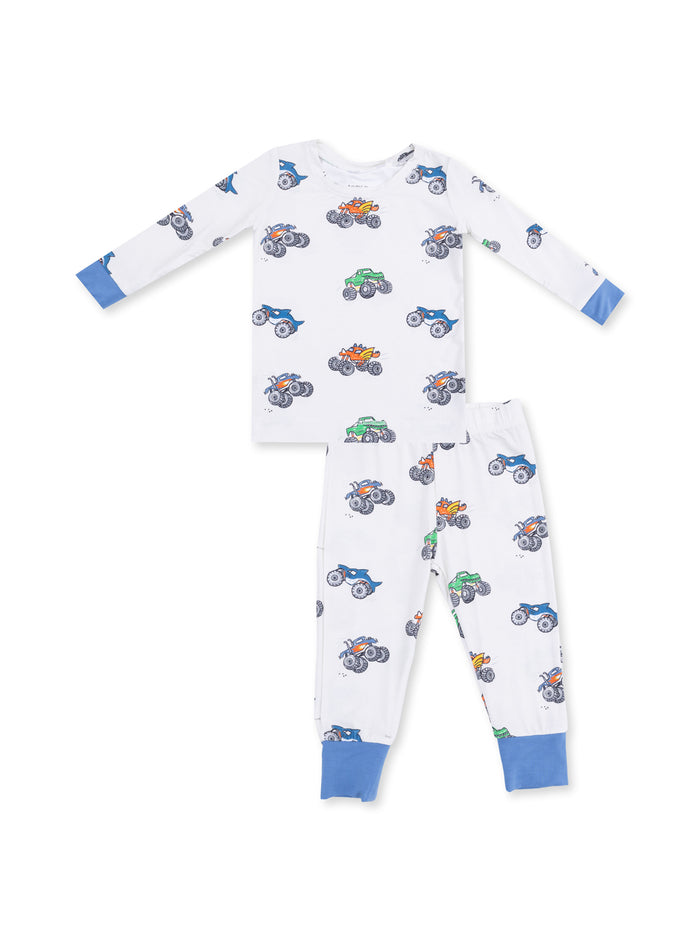 White pajamas with colorful monster truck prints, including long sleeves and matching pants, featuring blue accents.