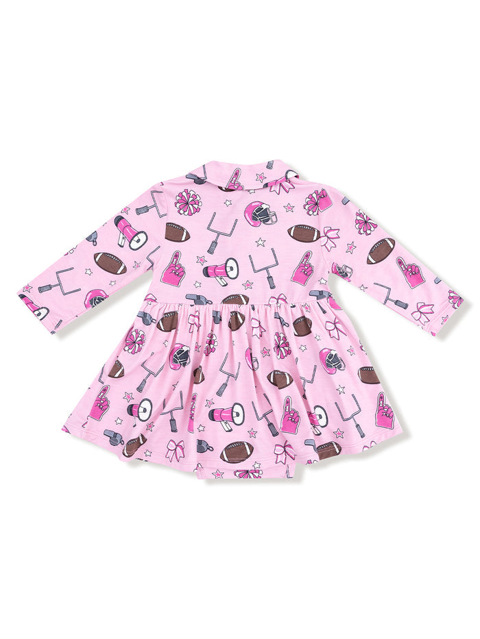 Pink dress with football and cheerleading patterns, featuring long sleeves and a flared skirt.