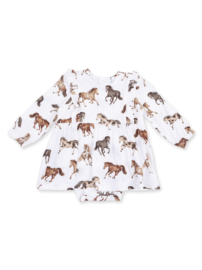 White dress with horse patterns and long sleeves, featuring ruffles and a bottom snap closure.