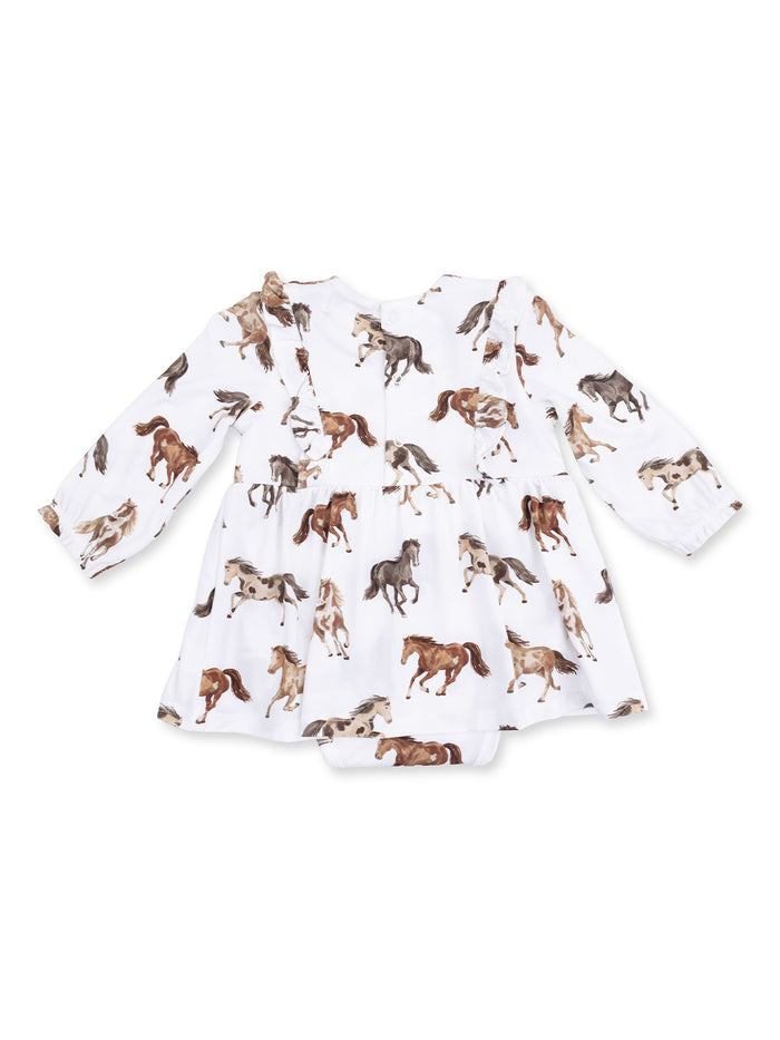 White dress with long sleeves featuring a playful horse print in various colors. Perfect for little ones.