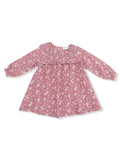 Pink floral dress with long sleeves and smocked bodice, perfect for casual outings or special occasions.