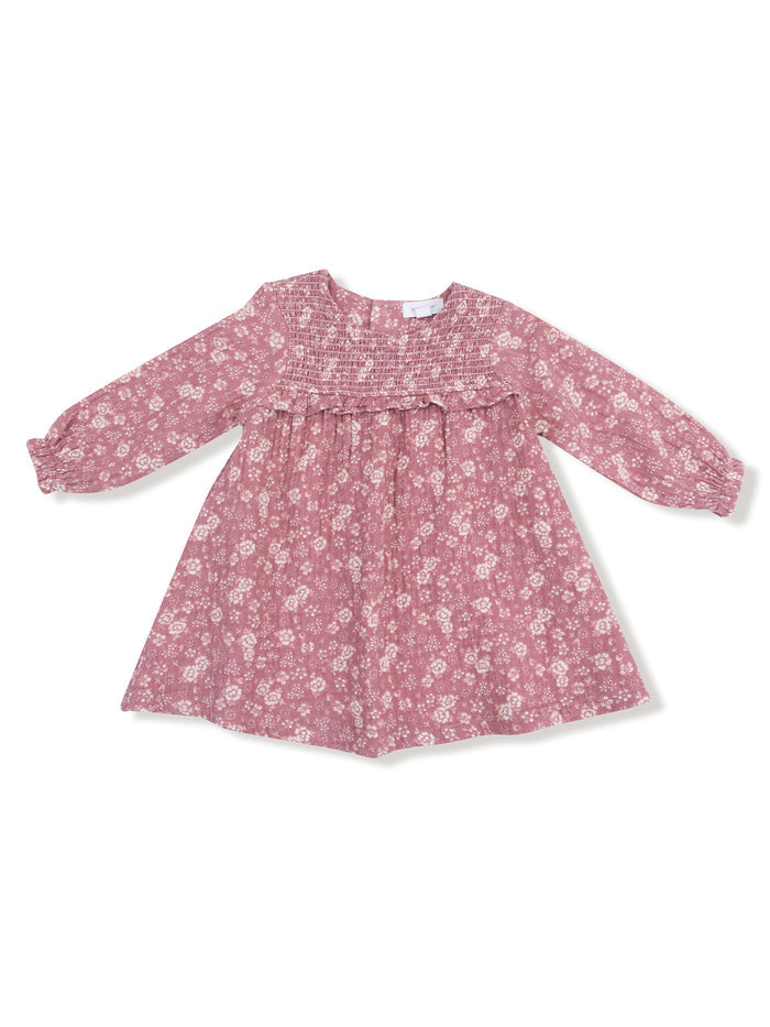 Pink floral dress with long sleeves and smocked bodice, perfect for casual outings or special occasions.