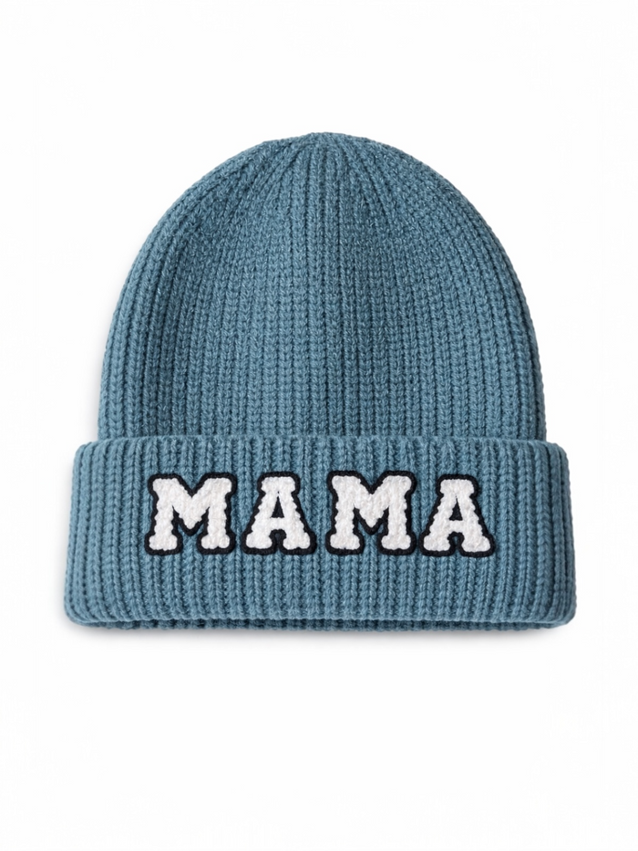 Blue knit beanie with a folded cuff featuring the word "MAMA" in white lettering.
